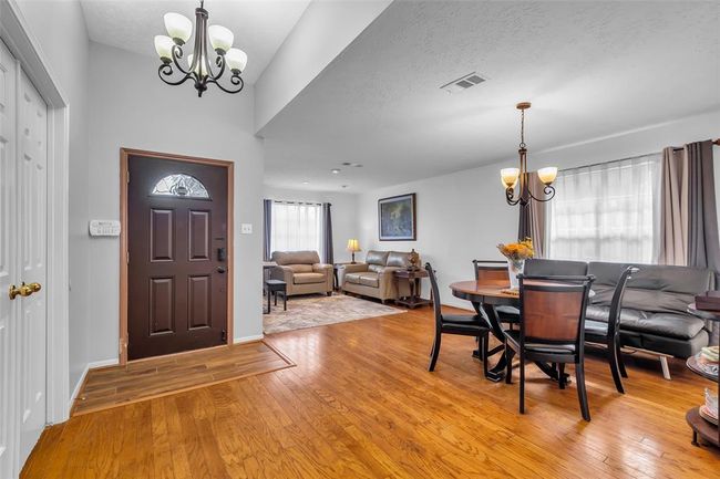 Spacious dining room and family room with gorgeous wood flooring and large windows for abundant natural lights. | Image 5