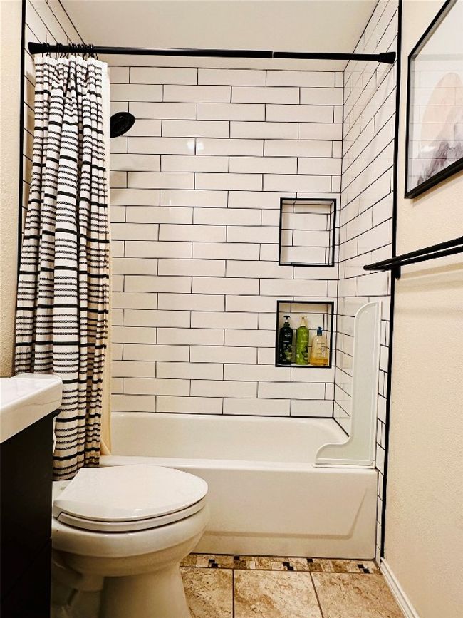 Bathroom featuring toilet, shower / tub combo with curtain, and baseboards | Image 20