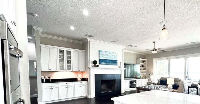 Fireplace and quality custom trim and built-ins by renowned DuraSupreme Cabinets. | Image 24