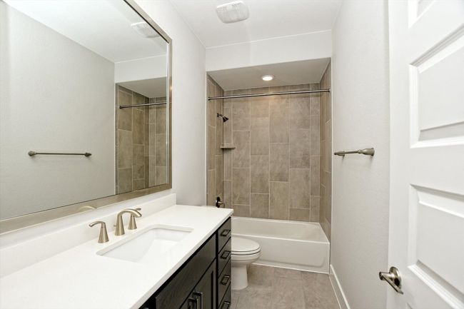 Full bathroom with toilet, vanity, and shower / washtub combination | Image 28