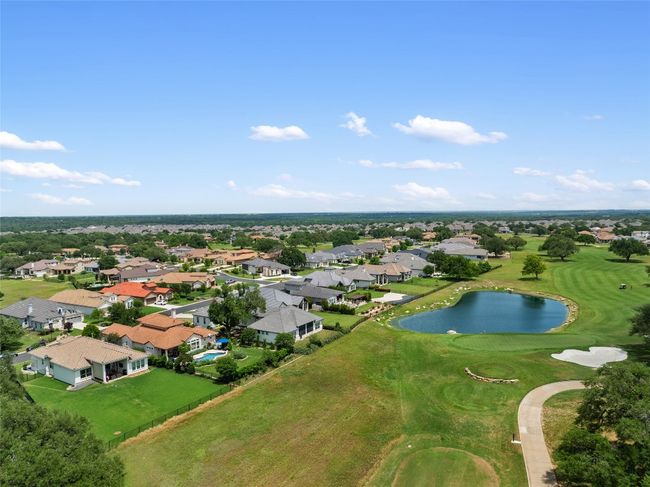 Birds view of home with a water and golf tee view. | Image 35
