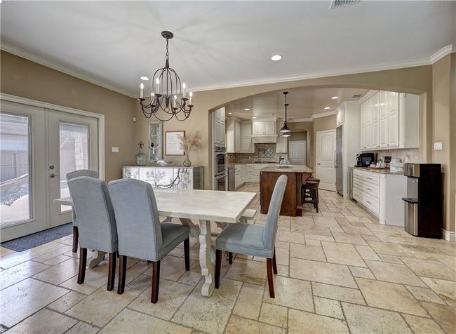 Open dining area blends the kitchen and living area. | Image 8