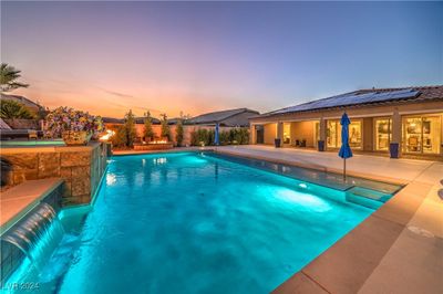 Expansive 894 square foot pool with a soaking deck, self-cleaning system, and a full spa, featuring stunning water and fire elements | Image 2