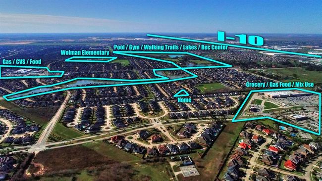 Another aerial view highlights the home's proximity to the elementary school it is zoned to within Katy ISD, as well as its convenient access to I-10 and nearby shopping. The neighborhood offers numerous amenities, including pools, a splash pad, a gym, tennis courts, and walking trails, providing ample opportunities for recreation and relaxation. | Image 50