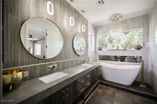 Master Bathroom with a soaking tub, double sink, visible vents, and tile walls | Image 54