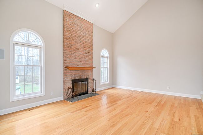 Family room with soaring ceilings and fireplace. | Image 12