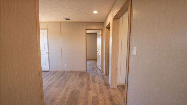 Hall with light wood-type flooring and recessed lighting | Image 16