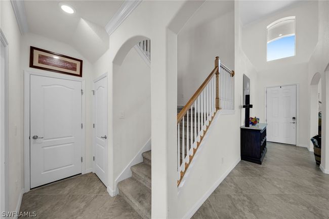Tiled foyer featuring crown molding | Image 19