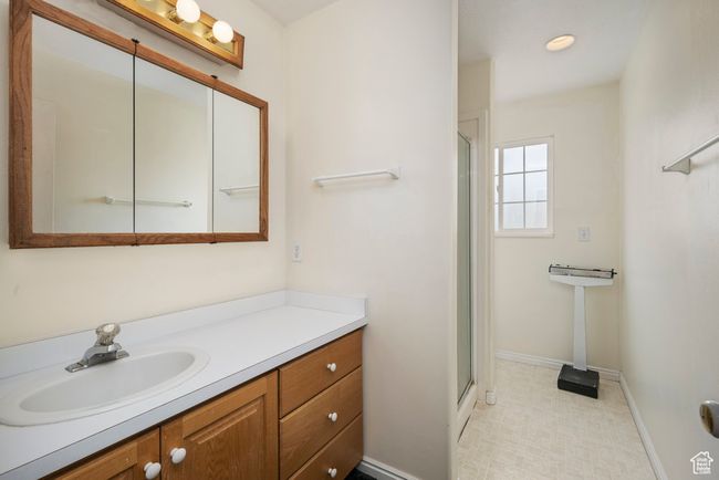 Full bath featuring vanity, baseboards, and a shower stall | Image 35