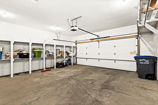 Two-stall Garage features GREAT shelving for storage & a floor drain. | Image 32