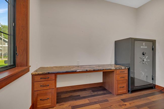 Office featuring a custom-built desk, offering a sleek and functional workspace with plenty of storage. | Image 62
