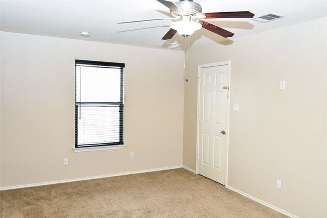 Empty room featuring light carpet, baseboards, visible vents, and a ceiling fan | Image 14