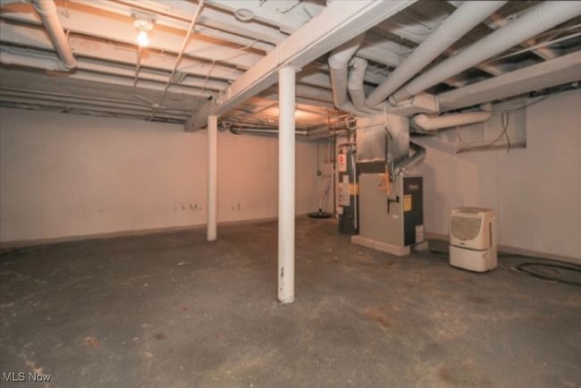 Unfinished basement featuring heating unit | Image 9
