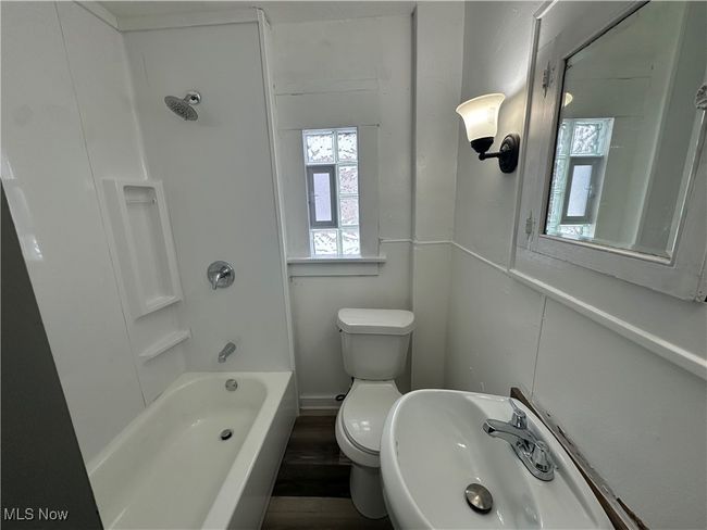 Bathroom with toilet, a sink, and bathing tub / shower combination | Image 26