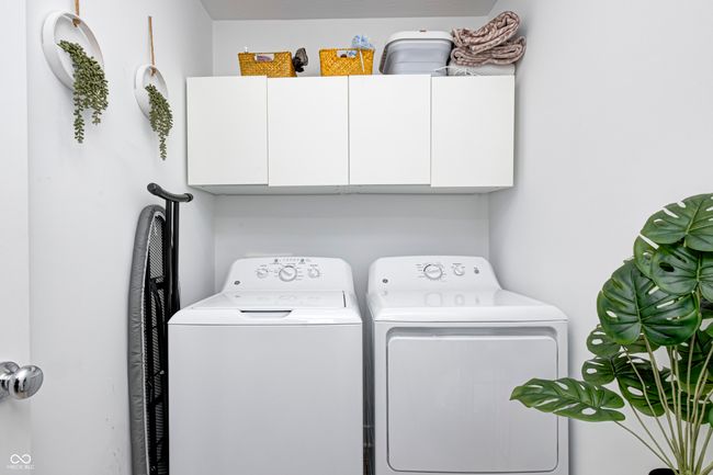 washroom with cabinet space and independent washer and dryer | Image 23