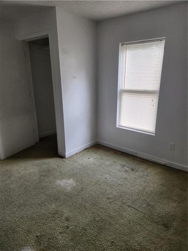 Carpeted empty room featuring a textured ceiling | Image 17