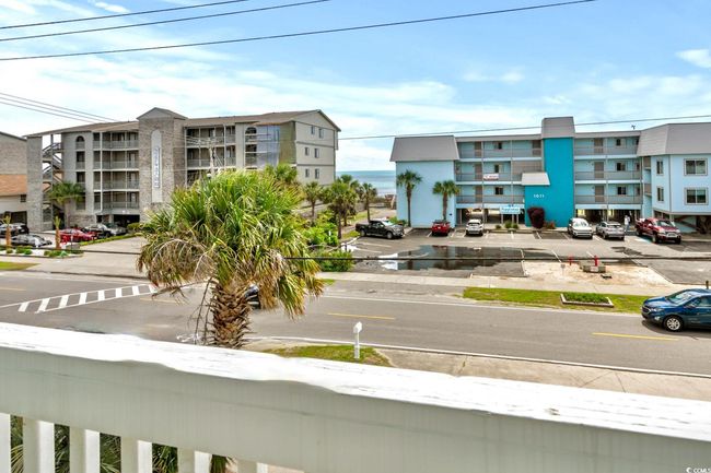 View of building exterior featuring uncovered parking | Image 29