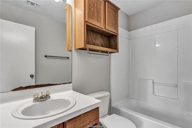Bathroom with vanity and shower combination | Image 13