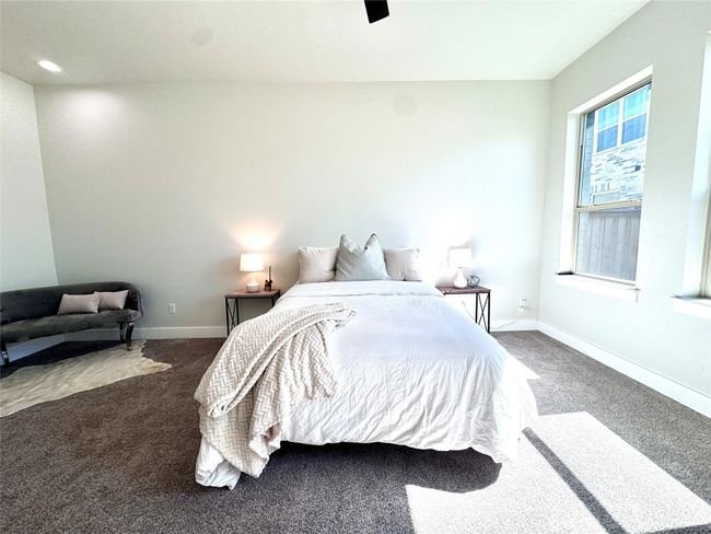 Carpeted bedroom with baseboards and a ceiling fan | Image 17