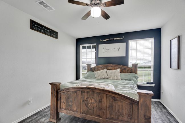 Bedroom with multiple windows, wood finished floors, and baseboards | Image 18