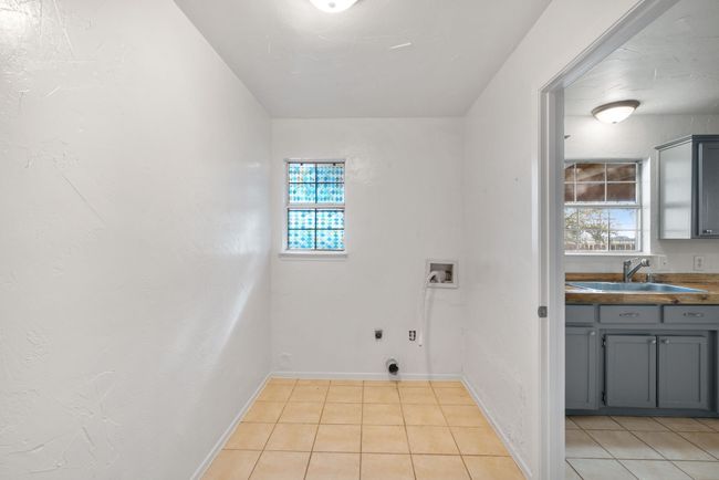 Washroom featuring electric dryer hookup, washer hookup, and light tile patterned floors | Image 24