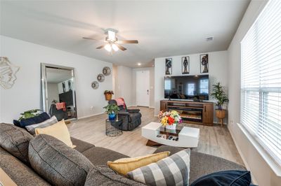 Living room with ceiling fan and light hardwood / wood-style flooring | Image 3