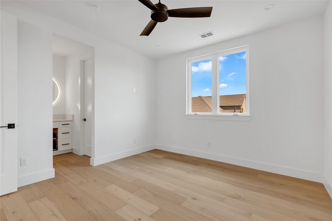 Empty room with a ceiling fan and light wood-type flooring | Image 32