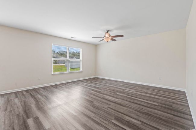 Livingroom featuring a ceiling fan and dark wood-type flooring | Image 13