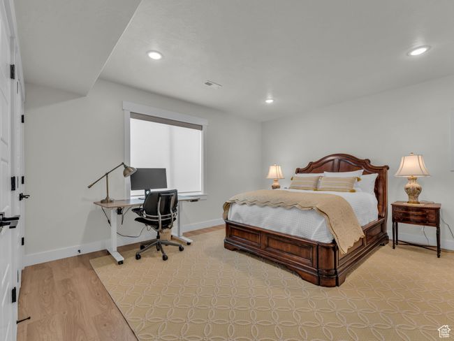 Bedroom with recessed lighting, a desk, light wood finished floors, and baseboards | Image 38