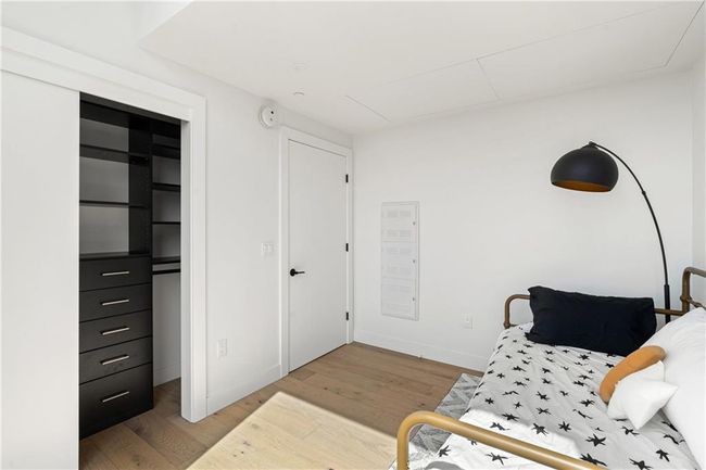 Sitting room with baseboards and wood finished floors | Image 21