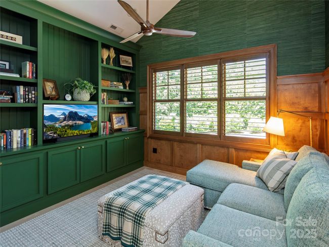 Den off main living room provides a cozy and private place to relax and read or watch TV on the Frame TV. Custom cabinetry and shelving, beamed ceiling with built-in ceiling speakers. | Image 25