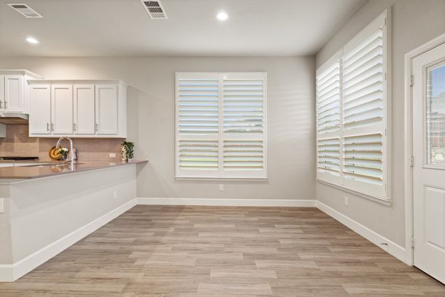 Unfurnished dining area with light wood-style flooring and recessed lighting | Image 9
