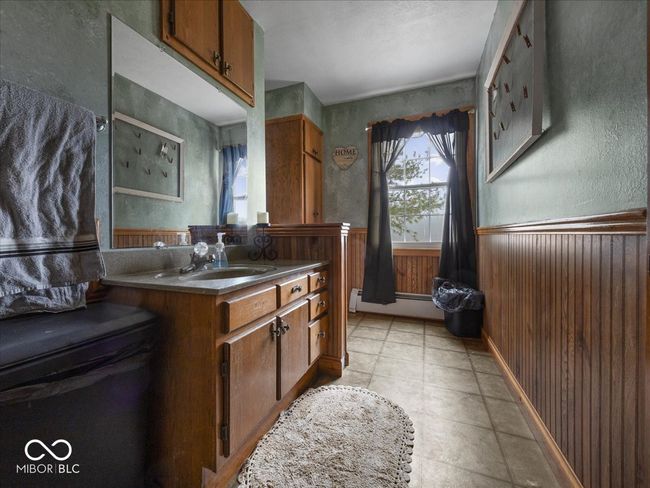 Just up from the Side mudroom and next to the kitchen is this flexspace. Currently has a sink and cabinetry for storage, but this could also hold a washer/dryer, or add a toilet for a half bath, maybe a room for your pets, lots of possibilities. | Image 25