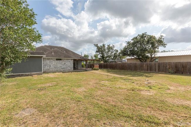 View of fenced backyard | Image 19