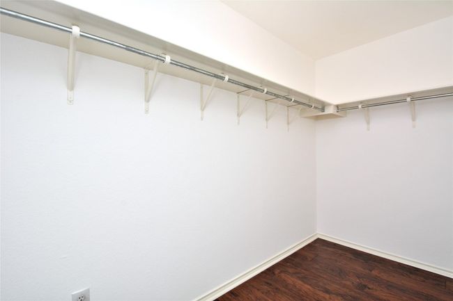 Walk in closet with dark wood-style flooring | Image 14
