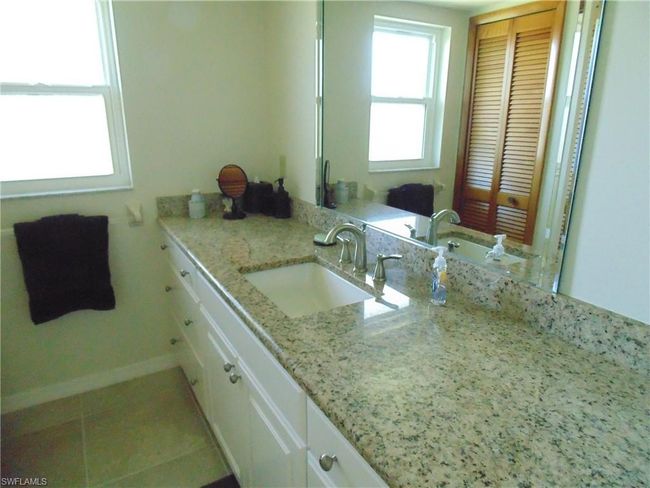 Bathroom with tile patterned floors, baseboards, and vanity | Image 16