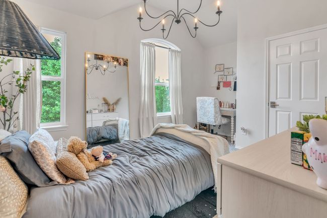 Bedroom with a chandelier and lofted ceiling | Image 26