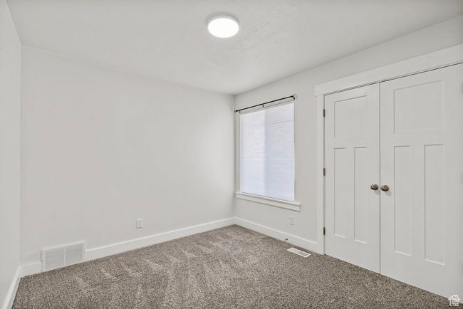 Unfurnished bedroom featuring carpet flooring and a closet | Image 16