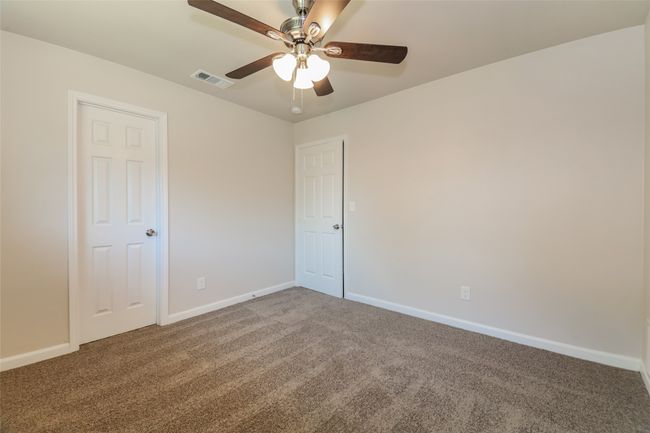 Carpeted spare room with a ceiling fan and baseboards | Image 22
