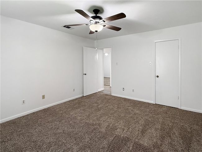 Unfurnished bedroom featuring carpet floors and a ceiling fan | Image 11