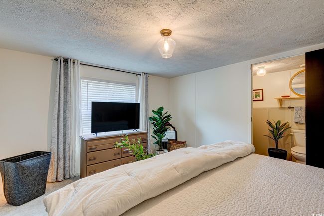Carpeted bedroom featuring a textured ceiling | Image 17