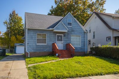 Bungalow-style home featuring a front yard, and a garage | Image 1