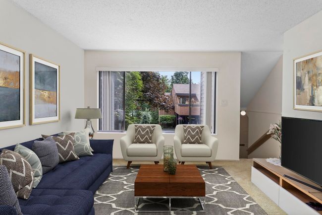 Living room with carpet floors and a textured ceiling | Image 8