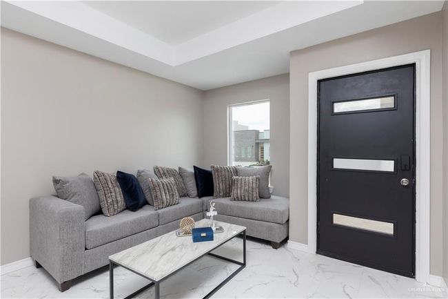 Living area featuring light marble finish floors and baseboards | Image 6
