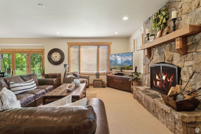 Living area featuring light carpet, a stone fireplace, and recessed lighting | Image 12