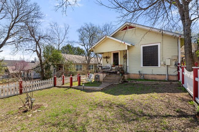 View of front of property with a front yard, fence, and covered porch | Image 33