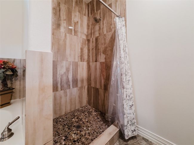 Bathroom with a tile shower | Image 22