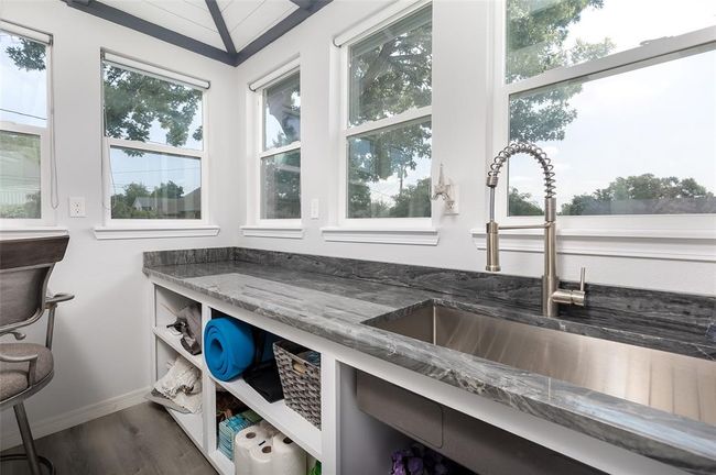 Room details featuring dark wood-type flooring, sink, and dark stone counters | Image 32