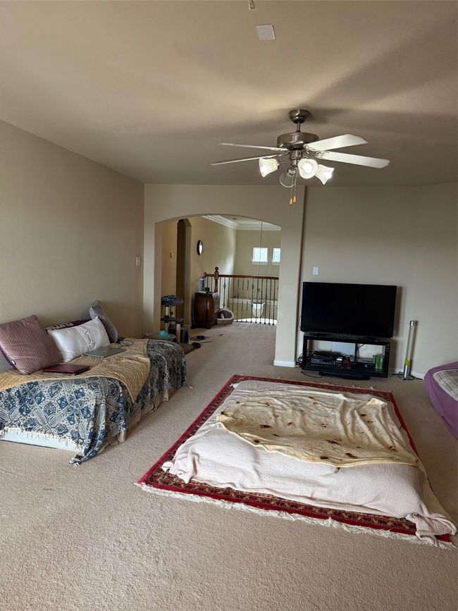 Bedroom featuring arched walkways, carpet, and a ceiling fan | Image 32