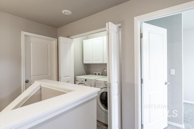 Laundry room with cabinet space, washer and dryer, and carpet | Image 18